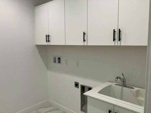 clothes washing area featuring electric dryer hookup, cabinets, sink, and hookup for a washing machine