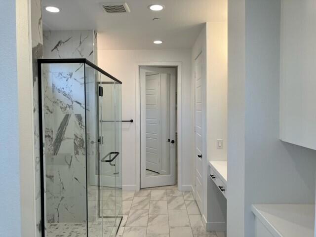 bathroom with vanity and walk in shower