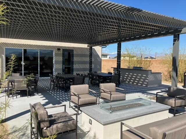 view of patio with an outdoor living space and a pergola