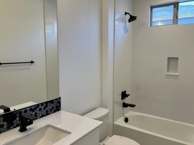 full bathroom featuring vanity, shower / bathtub combination, and toilet