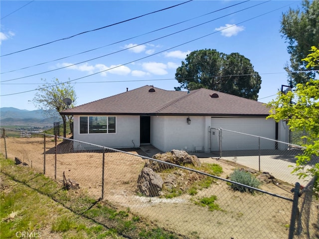 rear view of property featuring a mountain view and a garage