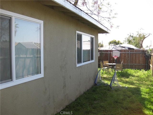 view of side of property with a lawn