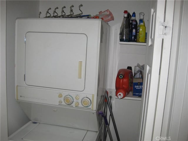 clothes washing area with stacked washer / drying machine