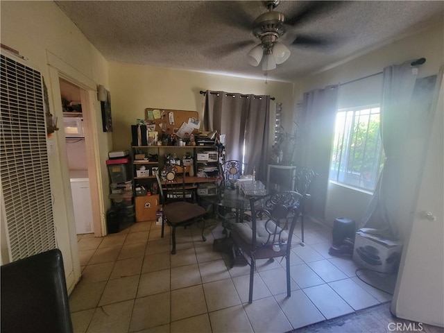 tiled dining space featuring ceiling fan and a textured ceiling