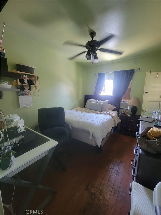 bedroom featuring dark hardwood / wood-style flooring and ceiling fan