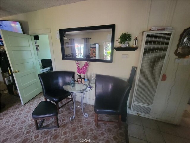 sitting room with tile patterned floors and a textured ceiling