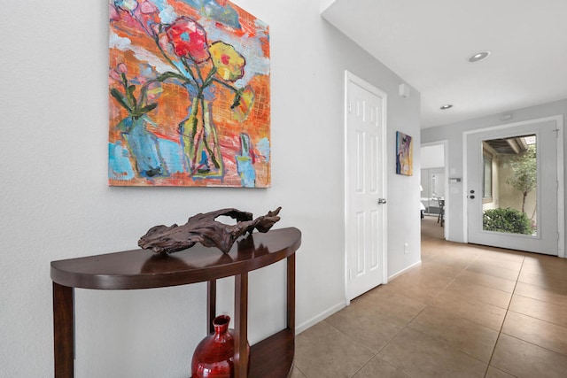 hallway featuring light tile floors