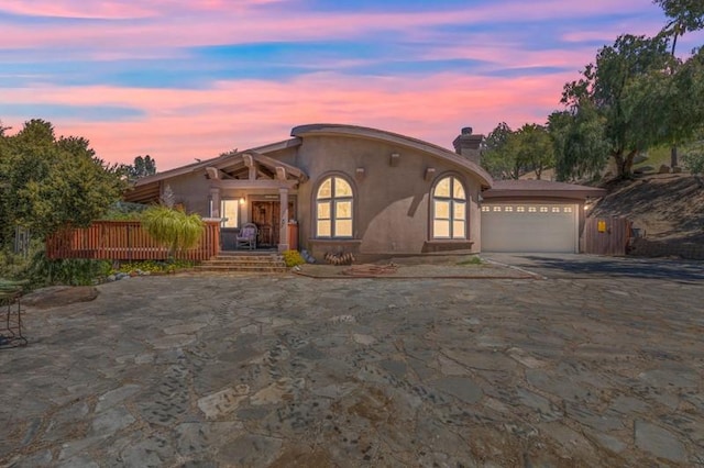 mediterranean / spanish-style home with a garage