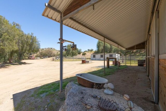 view of patio featuring an outbuilding