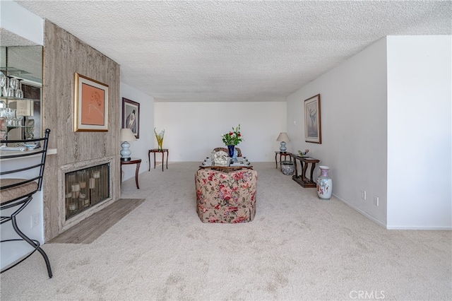 living room with a fireplace, a textured ceiling, and carpet flooring