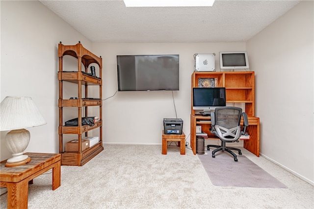 carpeted office space with a textured ceiling