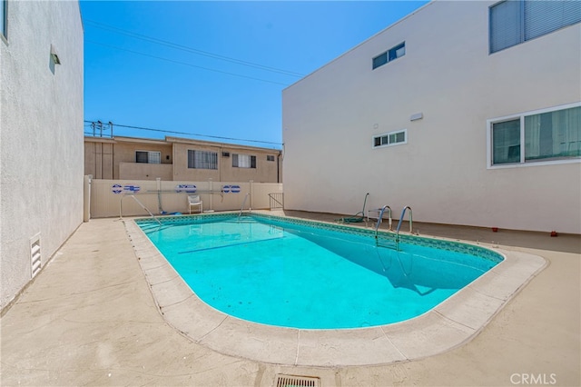 view of swimming pool featuring a patio area