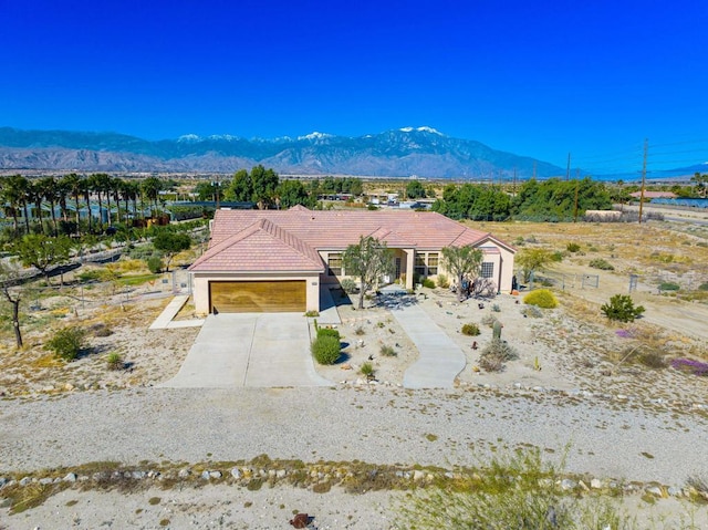 view of front facade featuring a mountain view and a garage