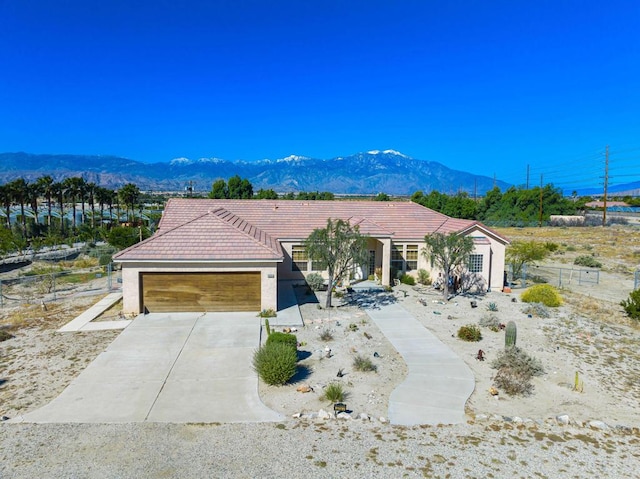 view of front of house featuring a garage and a mountain view