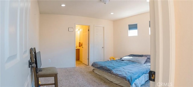 carpeted bedroom with ensuite bath