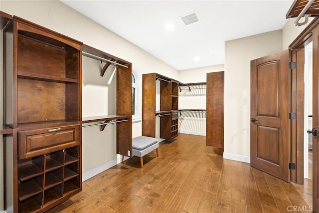 spacious closet with hardwood / wood-style flooring