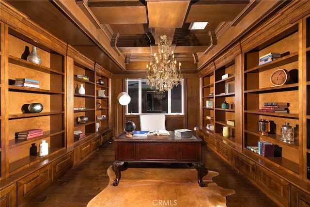 office area with dark wood-type flooring, coffered ceiling, an inviting chandelier, built in shelves, and beam ceiling