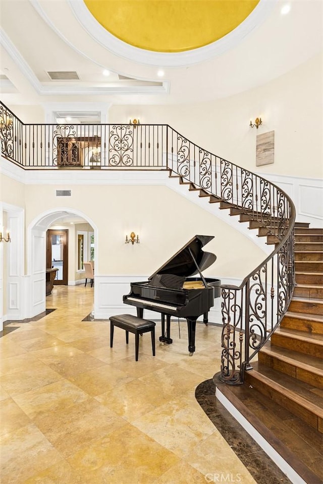 interior space with a high ceiling and a tray ceiling