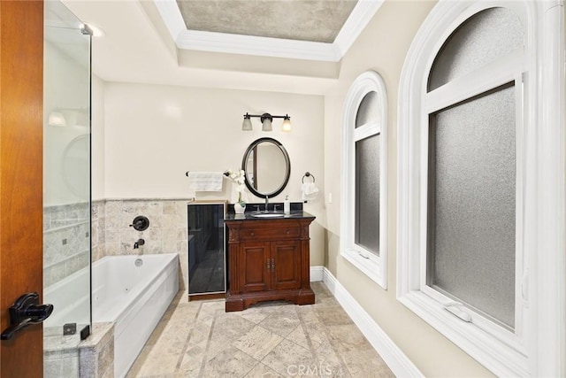 bathroom featuring vanity, a bathtub, and ornamental molding