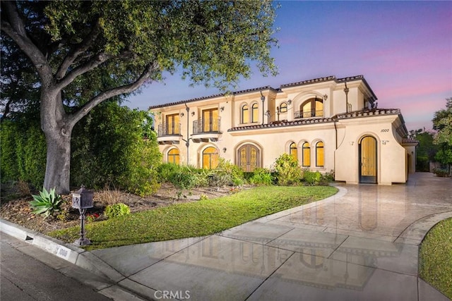 mediterranean / spanish-style home featuring a balcony