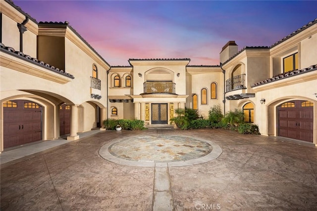 mediterranean / spanish-style house with french doors and a balcony