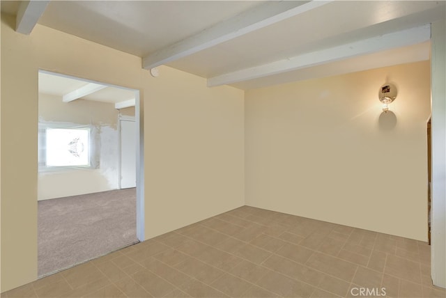 tiled spare room with beam ceiling