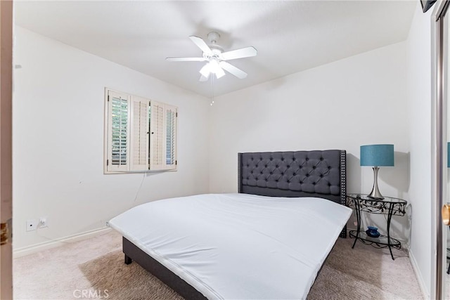 bedroom featuring ceiling fan and light carpet