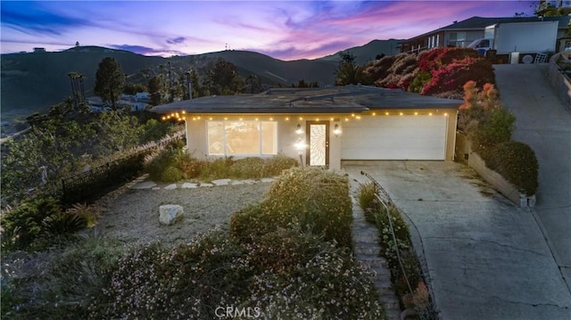 view of front facade featuring a mountain view and a garage