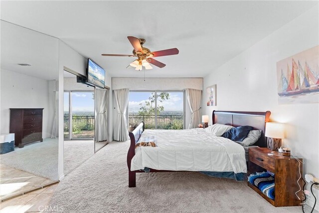 carpeted bedroom featuring ceiling fan and access to exterior