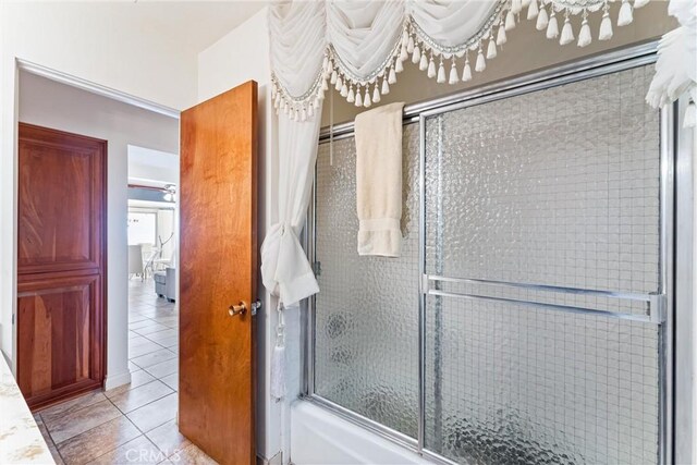 bathroom featuring tile patterned floors and combined bath / shower with glass door