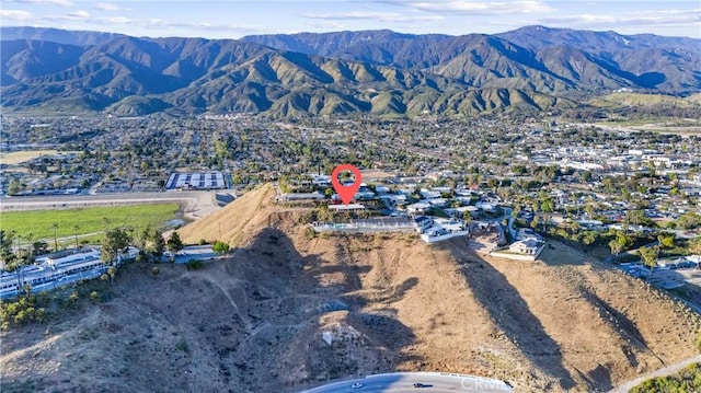 birds eye view of property featuring a mountain view