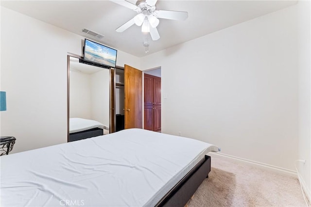 bedroom featuring ceiling fan and light carpet