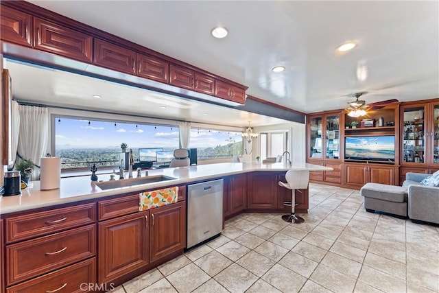 kitchen featuring a wealth of natural light, dishwasher, sink, and ceiling fan with notable chandelier