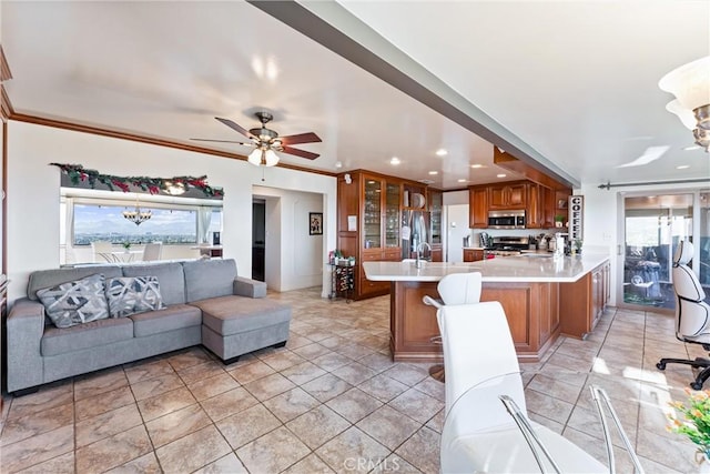 living room featuring ceiling fan with notable chandelier and ornamental molding