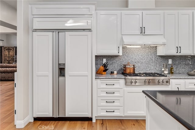 kitchen featuring light wood-type flooring, white cabinetry, light stone counters, and stainless steel gas cooktop