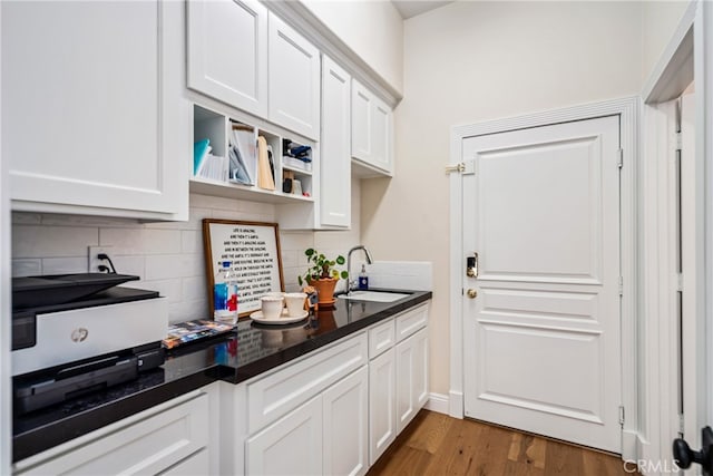 kitchen featuring tasteful backsplash, dark wood-type flooring, and white cabinetry