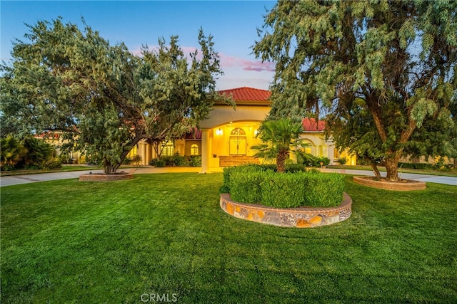 mediterranean / spanish-style house featuring a yard