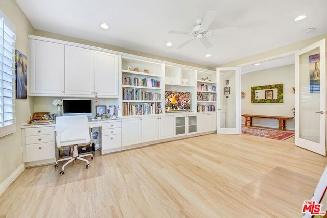 office space featuring light hardwood / wood-style flooring, built in desk, and ceiling fan