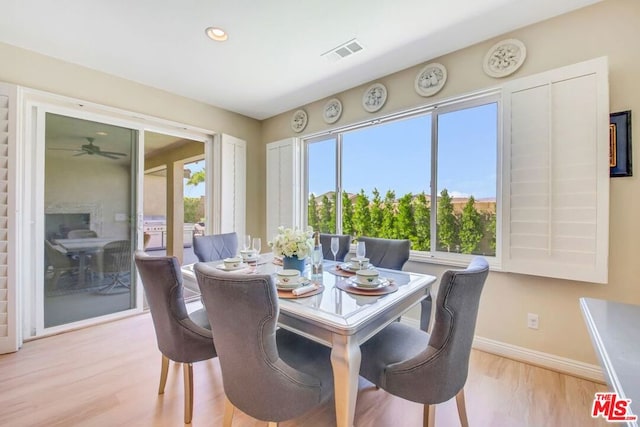 dining area with ceiling fan and light wood-type flooring