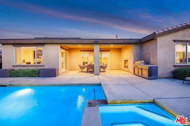 pool at dusk with a patio