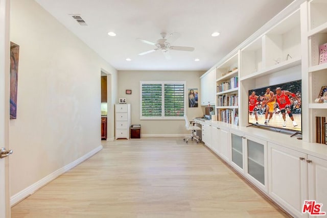 hallway with light hardwood / wood-style floors