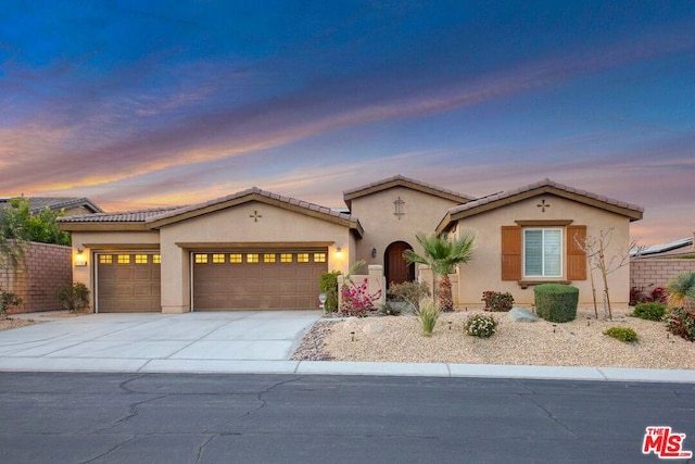 mediterranean / spanish-style house featuring a garage