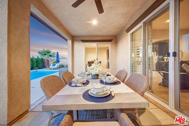 dining area with ceiling fan and a textured ceiling