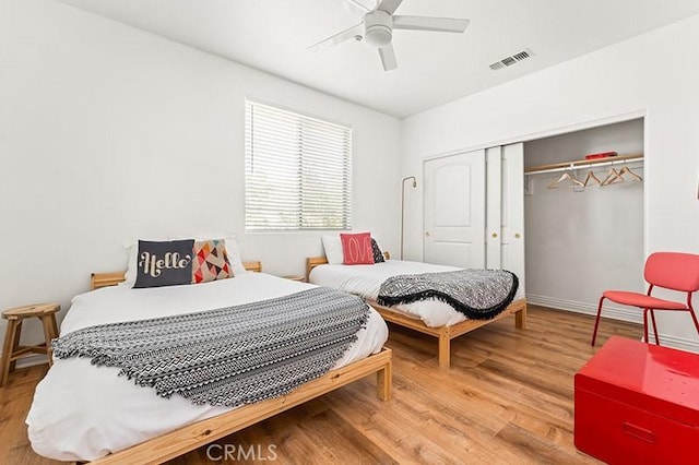 bedroom with ceiling fan, hardwood / wood-style floors, and a closet