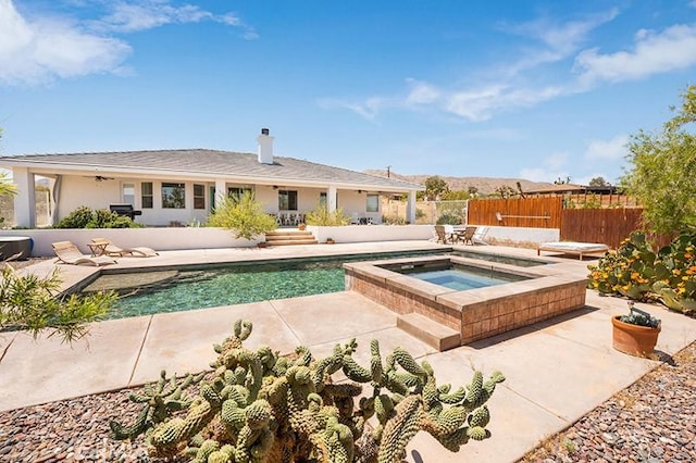 view of swimming pool with an in ground hot tub and a patio