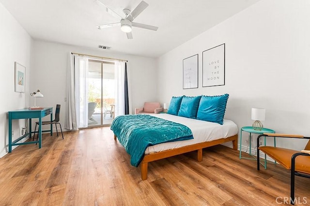 bedroom featuring ceiling fan, wood-type flooring, and access to outside