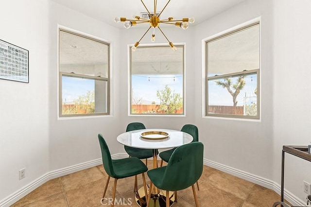 dining space with an inviting chandelier and light tile patterned floors