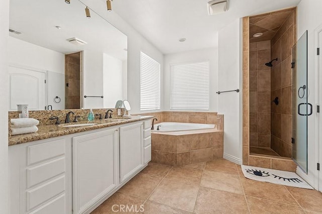 bathroom with vanity, tile patterned floors, and shower with separate bathtub