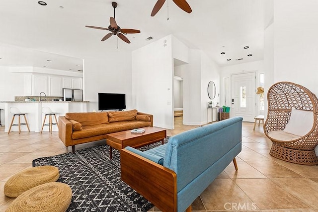 tiled living room featuring ceiling fan