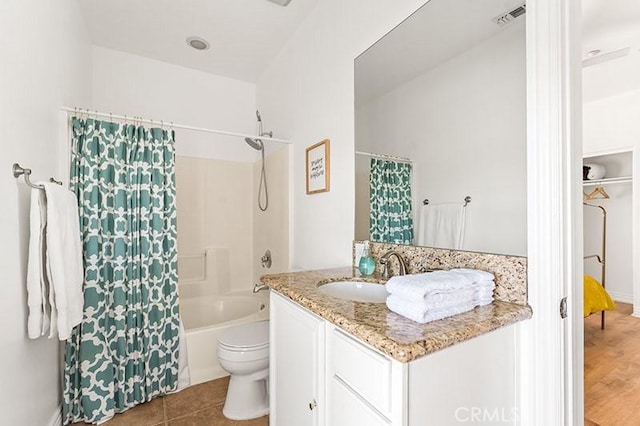 full bathroom featuring toilet, vanity, tile patterned floors, and shower / bath combo with shower curtain